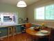 A dining area near the kitchen, featuring a window and bar seating that offers natural light and counter space at 4144 Fairport Rd, Kittrell, NC 27544