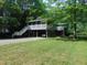 Two-story home featuring dual carports and a screened porch with a staircase entrance at 4144 Fairport Rd, Kittrell, NC 27544