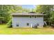 View of the rear of a two story home with light-blue siding and a well-kept lawn at 4144 Fairport Rd, Kittrell, NC 27544