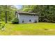 View of the rear of a two story home with light-blue siding and a well-kept lawn at 4144 Fairport Rd, Kittrell, NC 27544