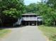 Two-story home featuring dual carports and a screened porch with a staircase entrance at 4144 Fairport Rd, Kittrell, NC 27544