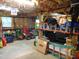 Spacious garage featuring parking space, various tools, lawn equipment and storage at 4144 Fairport Rd, Kittrell, NC 27544