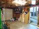 Spacious garage featuring an exterior door, various tools, equipment and storage at 4144 Fairport Rd, Kittrell, NC 27544