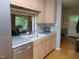 The kitchen features an undermount sink and stainless steel appliances, with a view to the outside from the window above at 4144 Fairport Rd, Kittrell, NC 27544