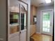 Kitchen with stainless appliances, light wood cabinets and mirrored accent to separate dining room at 4144 Fairport Rd, Kittrell, NC 27544