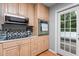 Updated kitchen featuring built-in microwave and oven, smooth cooktop, and mosaic backsplash at 4144 Fairport Rd, Kittrell, NC 27544