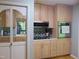Kitchen with stainless microwave and oven and light wood cabinets and decorative backsplash at 4144 Fairport Rd, Kittrell, NC 27544