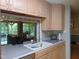 Bright kitchen features a window view into the adjacent living area and stainless steel dishwasher at 4144 Fairport Rd, Kittrell, NC 27544