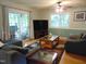 Comfortable living room featuring hardwood floors, a ceiling fan, and sliding glass doors leading to an outdoor space at 4144 Fairport Rd, Kittrell, NC 27544