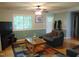 Cozy living room area showcasing wood floors, comfortable seating, and a glass coffee table at 4144 Fairport Rd, Kittrell, NC 27544