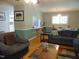 A bright living room features an open layout, hardwood floors, and a bar area that connects to the kitchen at 4144 Fairport Rd, Kittrell, NC 27544