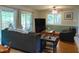 Well-lit living room with hardwood floors, a ceiling fan, and sliding glass doors leading to the outdoors at 4144 Fairport Rd, Kittrell, NC 27544