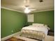 Cozy main bedroom features green walls, tile floors and ceiling fan at 4144 Fairport Rd, Kittrell, NC 27544