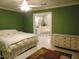 Spacious main bedroom featuring green walls, tile floors and opens to a bathroom at 4144 Fairport Rd, Kittrell, NC 27544