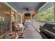 Inviting screened porch featuring hanging bed and cozy seating area at 4144 Fairport Rd, Kittrell, NC 27544