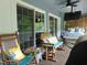 Relaxing screened-in porch with outdoor seating, a bed swing, ceiling fan, and a mounted TV at 4144 Fairport Rd, Kittrell, NC 27544