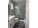 Modern bathroom featuring dual sinks, glass shower, and marbled tile at 431 Mayview Dr, Creedmoor, NC 27522