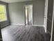 Bedroom with luxury vinyl plank flooring, neutral paint, base trim, and natural light from window at 431 Mayview Dr, Creedmoor, NC 27522