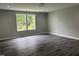 Bedroom with luxury vinyl plank flooring, recessed lighting, neutral walls and two windows for natural light at 431 Mayview Dr, Creedmoor, NC 27522