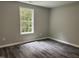 Bedroom features luxury vinyl plank flooring, neutral paint and a window providing natural light at 431 Mayview Dr, Creedmoor, NC 27522