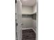 Walk-in closet featuring wooden floors, neutral walls and ample storage space with white shelves at 431 Mayview Dr, Creedmoor, NC 27522
