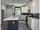 Modern kitchen with white cabinets, dark backsplash, and stainless steel appliances at 431 Mayview Dr, Creedmoor, NC 27522