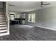 Spacious living room leading into kitchen featuring dark floors and neutral walls at 431 Mayview Dr, Creedmoor, NC 27522
