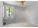 Neutral bedroom features ceiling fan, large window, and carpet for comfort at 4705 Walden Pond Dr # 110-C, Raleigh, NC 27604