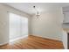 Inviting dining area featuring hardwood floors, elegant chandelier, and natural lighting at 4705 Walden Pond Dr # 110-C, Raleigh, NC 27604