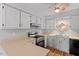 Traditional kitchen features painted cabinets, stainless appliances, and double sink at 4705 Walden Pond Dr # 110-C, Raleigh, NC 27604