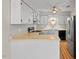 Traditional kitchen features painted cabinets, stainless appliances, and refrigerator at 4705 Walden Pond Dr # 110-C, Raleigh, NC 27604