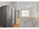 Bright kitchen features painted cabinets and a stainless steel refrigerator at 4705 Walden Pond Dr # 110-C, Raleigh, NC 27604