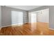 Open living room with hardwood floors, neutral walls, and bright natural lighting at 4705 Walden Pond Dr # 110-C, Raleigh, NC 27604