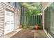 Rear patio featuring a storage shed and green space, accessed by a sliding glass door at 4705 Walden Pond Dr # 110-C, Raleigh, NC 27604