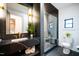Modern bathroom featuring black marble countertop, a glass shower, and a toilet at 500 Grigsby Ave, Holly Springs, NC 27540