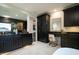 Elegant bathroom featuring black cabinets, gold fixtures, marble floors, and a makeup vanity at 500 Grigsby Ave, Holly Springs, NC 27540