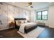 Stylish bedroom features a king-size bed with accent wall, wood floors, and modern decor at 500 Grigsby Ave, Holly Springs, NC 27540
