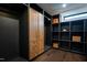 Spacious walk-in closet with custom shelving, wooden cabinets, and dark gray accents at 500 Grigsby Ave, Holly Springs, NC 27540