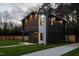 Modern two-story home with a well-manicured lawn, a concrete driveway, and stylish exterior lighting at 500 Grigsby Ave, Holly Springs, NC 27540