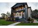 Two-story home with a balcony, elegant lighting, and stone steps leading to the front entrance at 500 Grigsby Ave, Holly Springs, NC 27540