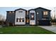 Contemporary two-story home with a dark garage door, modern siding, and manicured lawn at 500 Grigsby Ave, Holly Springs, NC 27540