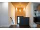 Hallway with decorative lighting, accent wall, and access to stairs and kitchen at 500 Grigsby Ave, Holly Springs, NC 27540