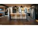 Spacious kitchen featuring a central island, stainless steel appliances, and modern pendant lighting at 500 Grigsby Ave, Holly Springs, NC 27540