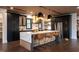 Modern kitchen with an island, pendant lights, stainless steel appliances, and designer finishes at 500 Grigsby Ave, Holly Springs, NC 27540