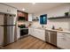 Well-lit kitchen featuring stainless steel appliances, white cabinets, and modern fixtures at 500 Grigsby Ave, Holly Springs, NC 27540