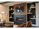Cozy living room with a fireplace, built-in shelves, and contemporary decor for relaxing at 500 Grigsby Ave, Holly Springs, NC 27540