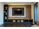 Entertaining living room featuring a built-in entertainment center with accent wall at 500 Grigsby Ave, Holly Springs, NC 27540