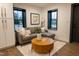 Cozy living room area with a comfortable gray couch, round wood table, and ample natural light at 500 Grigsby Ave, Holly Springs, NC 27540