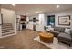 Open-concept living space with modern kitchen, stairs, and stylish furniture, perfect for entertaining guests at 500 Grigsby Ave, Holly Springs, NC 27540
