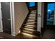 Modern staircase featuring elegant lighting, dark wood steps, and a sleek design at 500 Grigsby Ave, Holly Springs, NC 27540